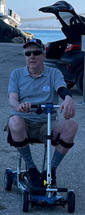 McLeod syndrome patient Mark Wagner sporting a brand new scooter as his cruise ship docks in Olympia, Greece, October 2022.