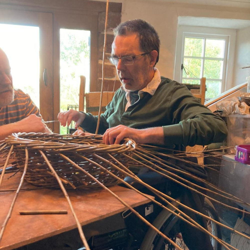 Peter Clark weaving a basket