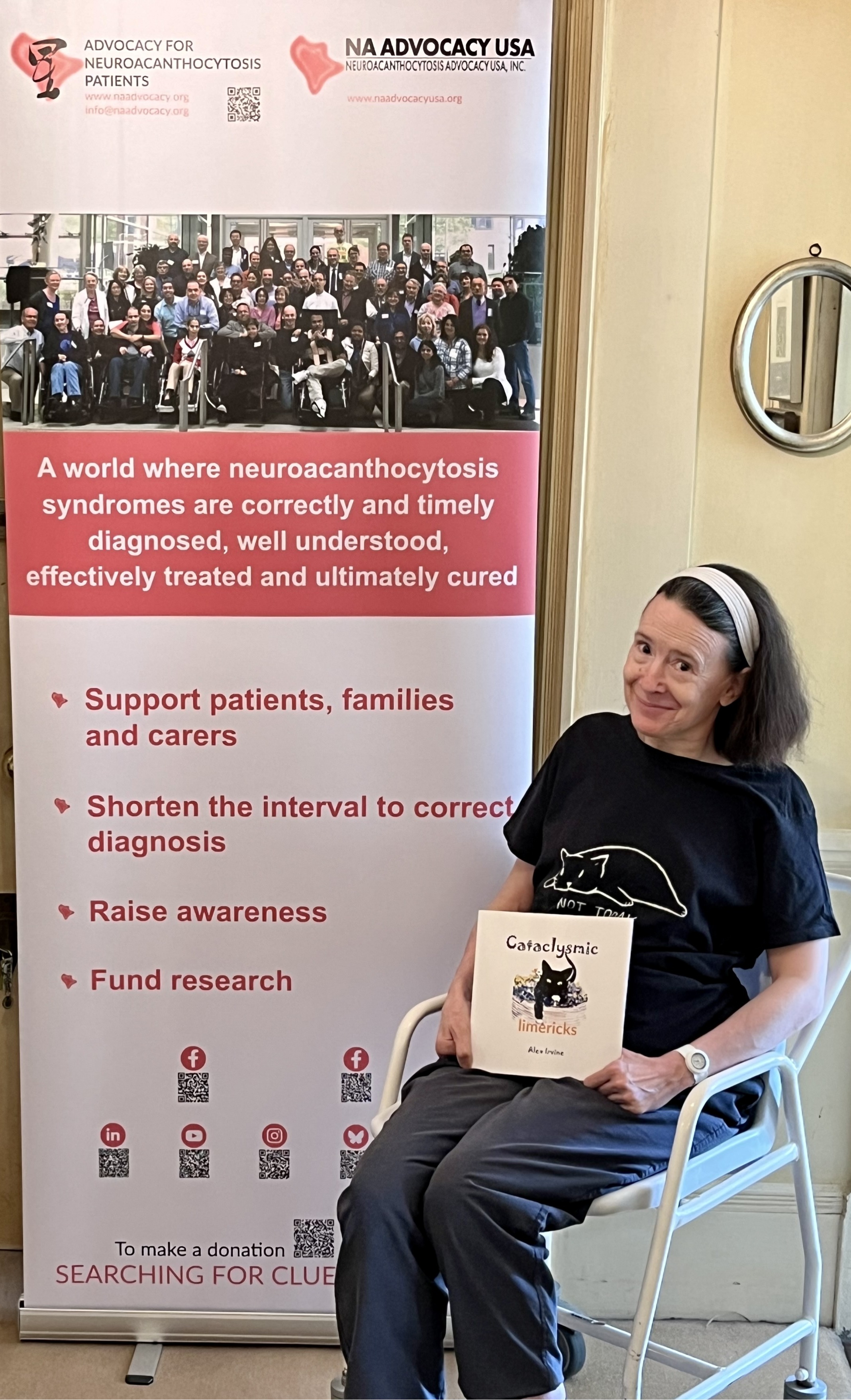 Alex Irvine with her published book Cataclysmic Limericks (2024) in front of our new poster