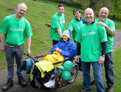 Alex Irvine carefully carried by kind volunteers for the walk