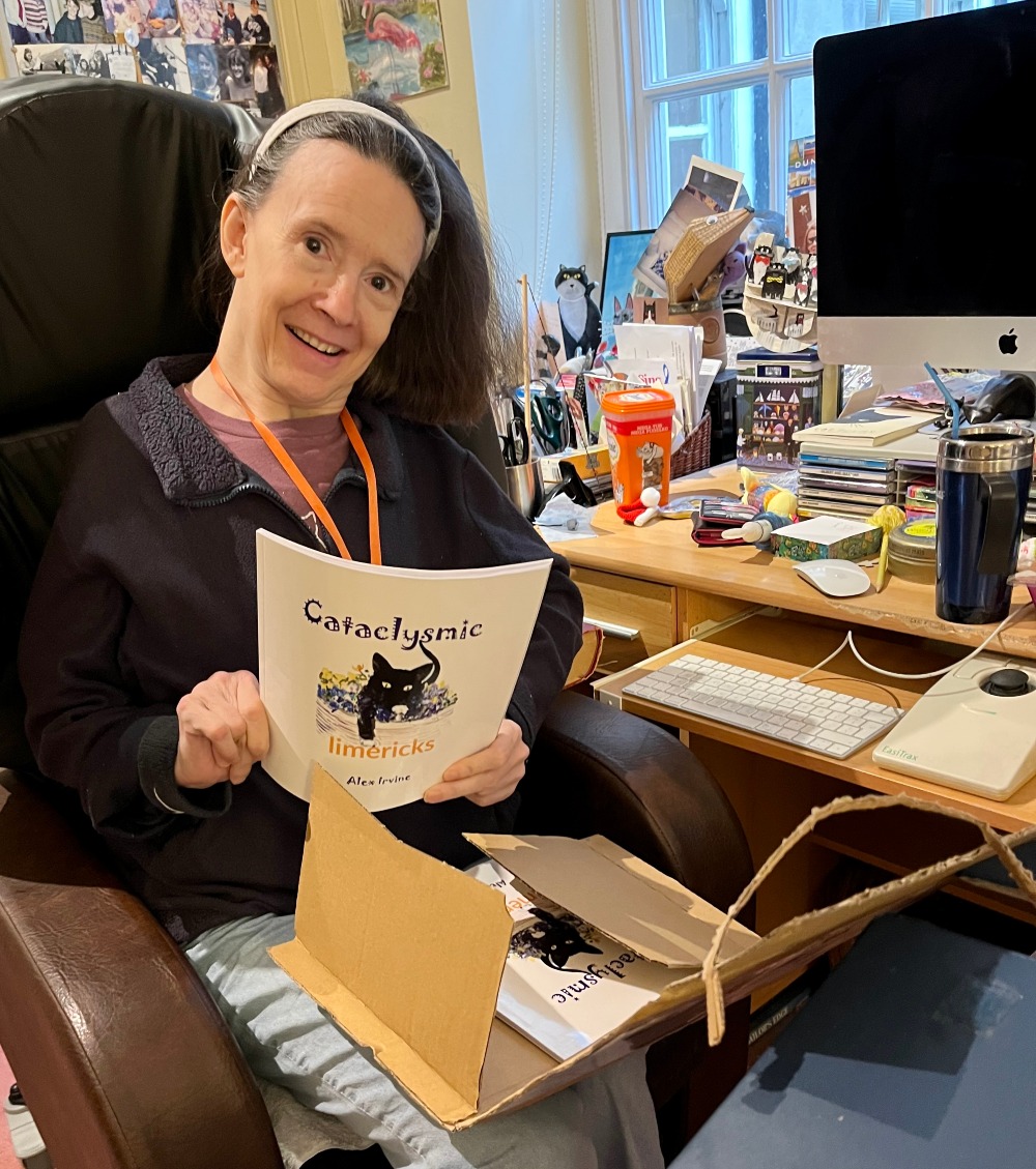 Alex Irvine unpacking the copies of Cataclysmic Limericks she'll sell in person