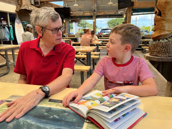 Mark and grandchild #3 discuss a book